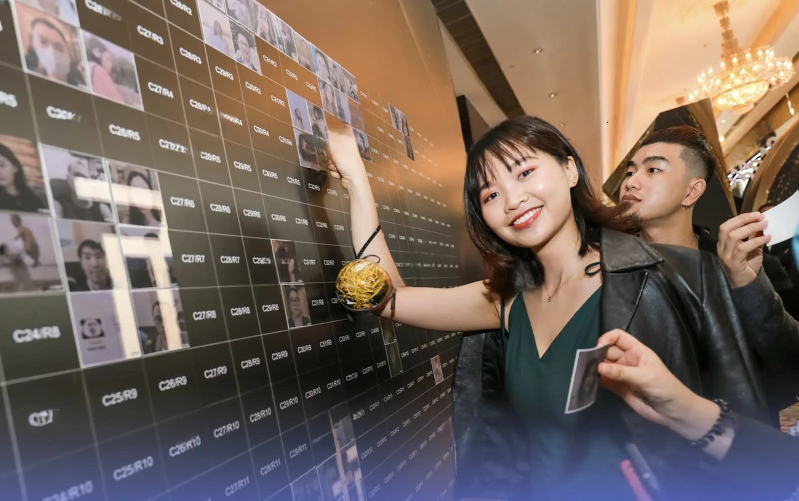 Guests in front of a photo mosaic wall